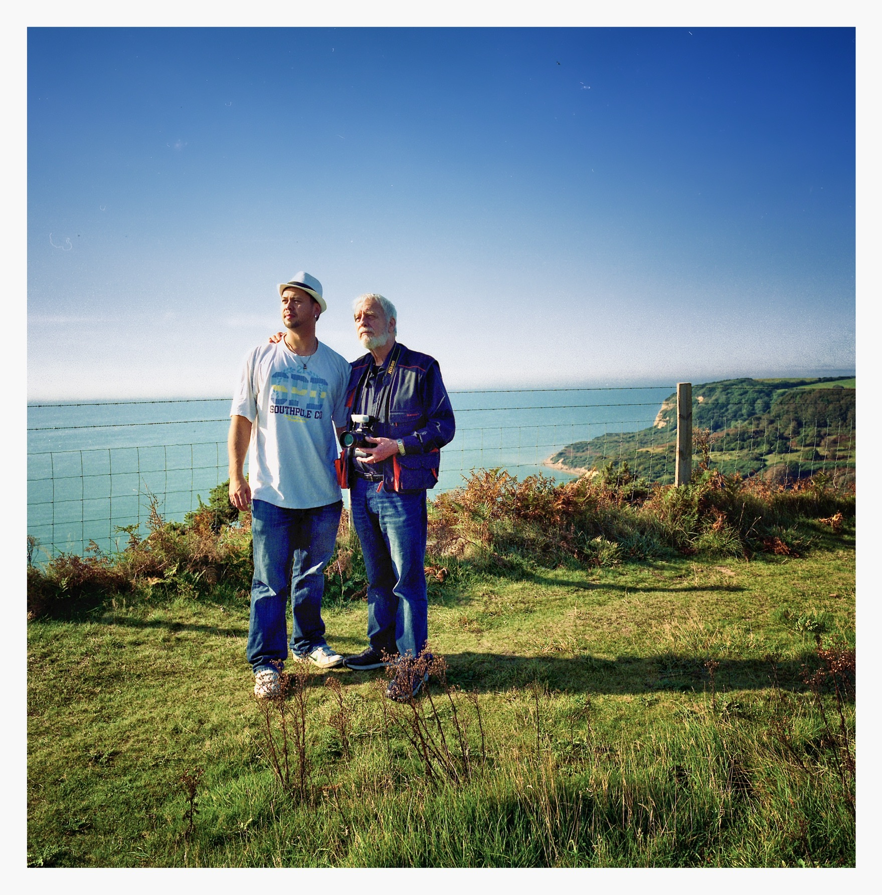 A young Alwood Wick with his father on the coast, holding the Nikon film camera that started it all