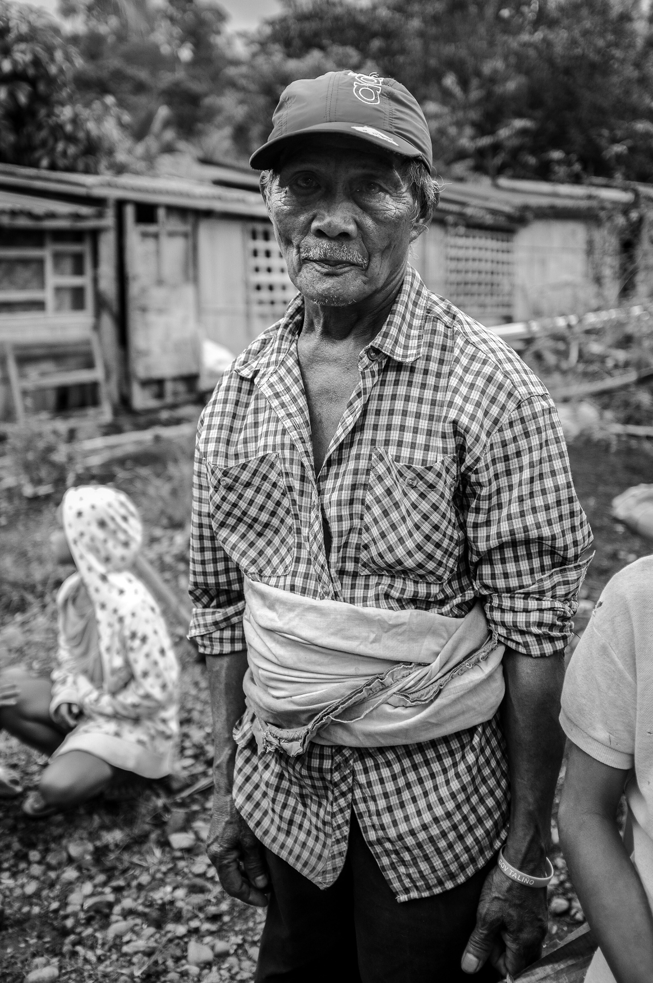 Black and white portrait of a Filipino elder in a village
